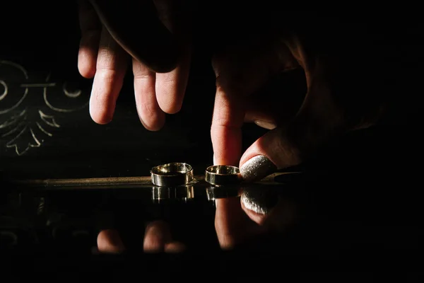 Un hombre recoge anillos de boda. Los anillos de boda son de cerca —  Fotos de Stock