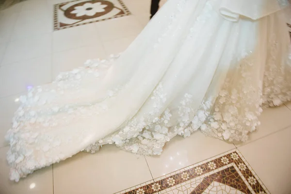 Part of the bride's wedding dress close up — Stock Photo, Image