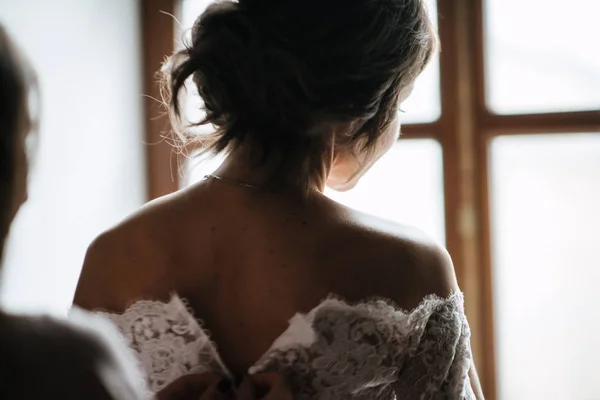 Наречена біла мереживна весільна сукня. Наречена допоможе одягнути весільну сукню — стокове фото