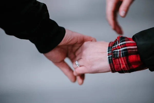 Man and woman hold hands close up