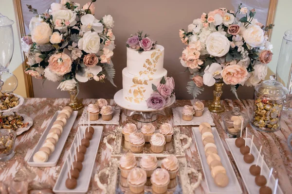 Big white wedding cake with fruit is on the table