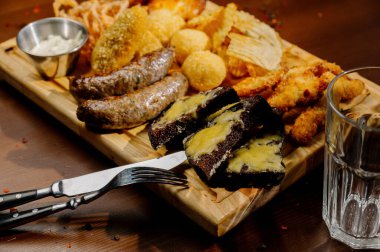 Masada bir sürü farklı lezzetli yemek var. Masada çeşitli abur cuburlar ve antipastalar var. Restoran menüleri. Restoran masası, bir sürü farklı yemek..