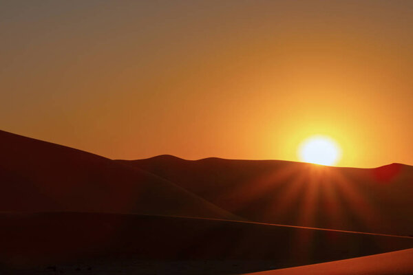 Sunset over the sand dunes in the Namib desert.