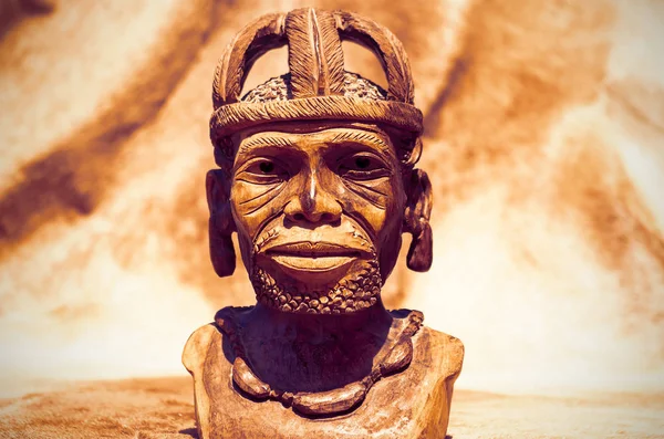 African art. Close up of African traditional wooden Statue figurine on a fur background