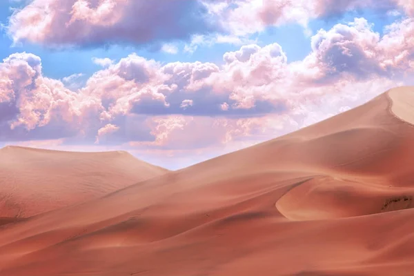 Beautiful gold sand dunes and beautiful sky with bright clouds in the Namib desert