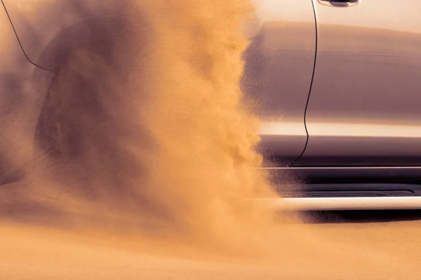 Close up of a golden car stuck in the sand in the Namib desert. Africa