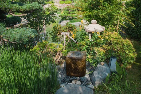 Bamboo sound water fountain or Shishi Odoshi and stone lantern are major components in traditional Japanese Zen Garden.
