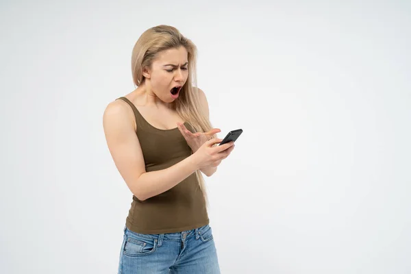 Young Girl Indignant Angry Looking Phone Isolated White Background — Stock Photo, Image