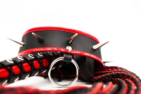 Sex toys for bdsm. Leather whip and collar with spikes isolated on white background