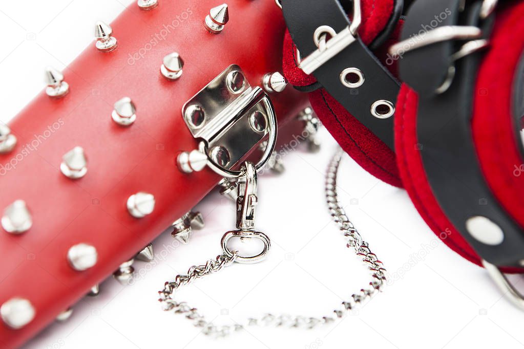 Sex toys for bdsm. Leather handcuffs and clamps for hands with thorns. Isolated handcuffs with chain on white background