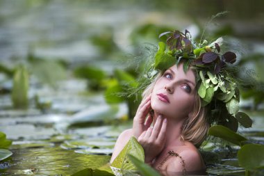beautiful sexy woman bathes in a lake with water lilies clipart