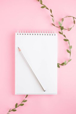 Defter, beyaz çarşaf, kalem. Pembe arka plan