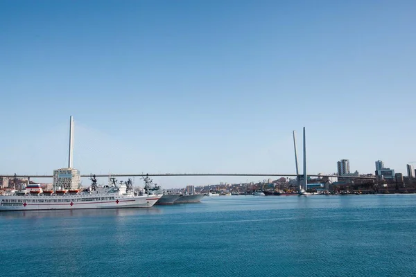 Bridge in Industrial city. Sunny weather. Sea and sky