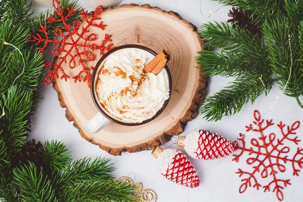 Cup of cacao with cinnamon. New Year decorations