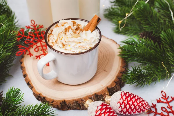 Cup of cacao with cinnamon. New Year decorations