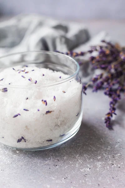 Salt scrub, lavender, towel on Grey background