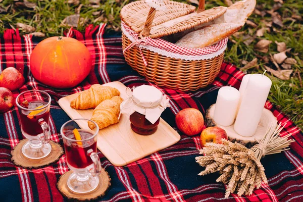 Autumn picnic. Mulled wine,picnic basket, bred, pumkin, jam, croissant