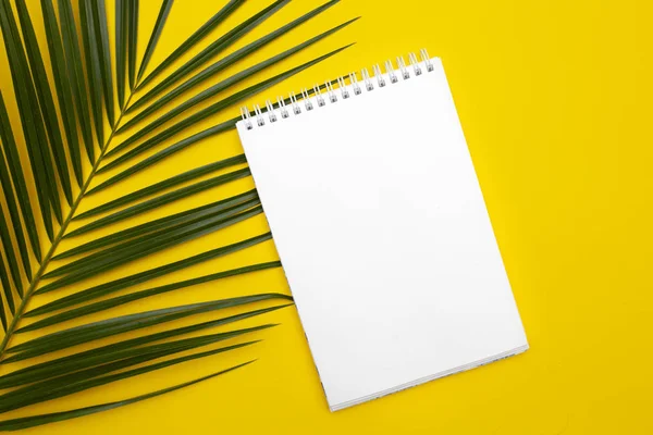 White sheet on yellow back and palm leaves