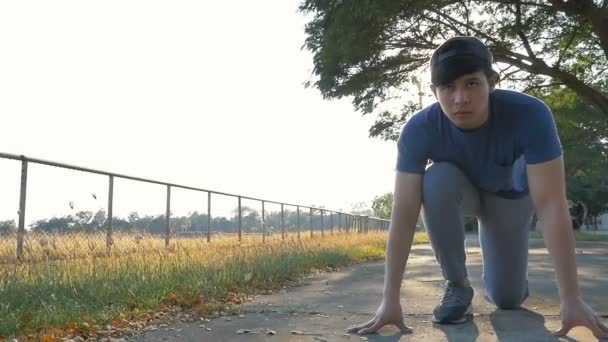 Young Asian Man Starting Position Ready Run Slow Motion Pan — Stock Video