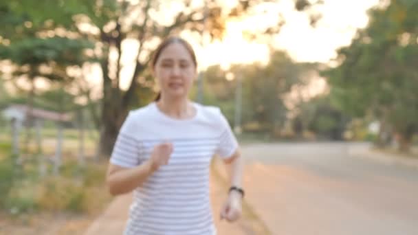 Asian Woman Wearing Smart Wrist Band While Running Slow Motion — Stock Video