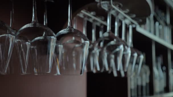 清洁的葡萄酒眼镜倒置在餐厅的酒吧架上方 放大拍摄 — 图库视频影像