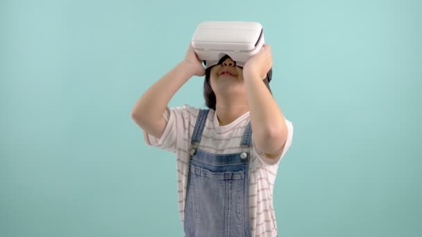 Asian Girl Virtual Reality Glasses Playing Virtual Game Blue Green — Stock Video