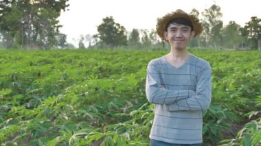 Manyok tarlalarında gülümseyen mutlu genç Asyalı Çiftçi Portresi,Yavaş çekim