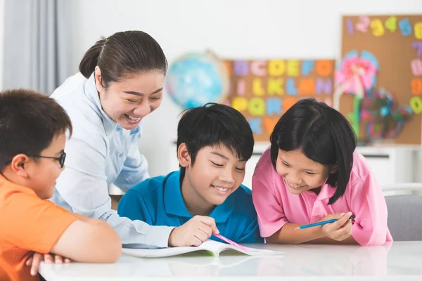 Young Asian Teacher Helps Young School Kids Class Close — Stock Photo, Image