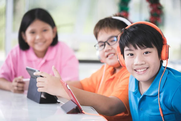 Asiatisches Kind Spielt Gemeinsam Tablet Computer Und Blickt Kamera Mit — Stockfoto