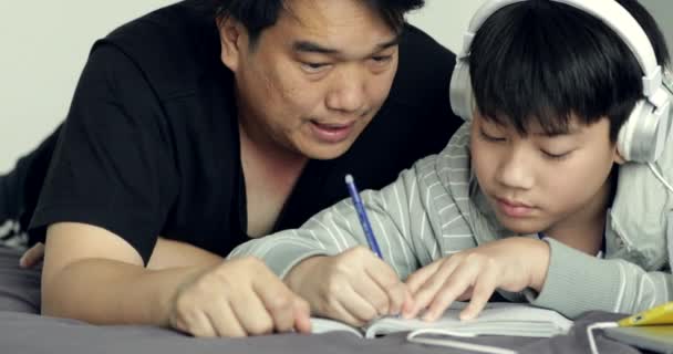 Dolly Shoot Front Asian Father Helps His Young Son While — Stock Video