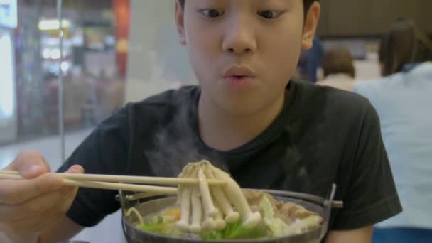 アジアのかわいい男の子のスローモーションを楽しむ笑顔で日本食を食べること — ストック動画