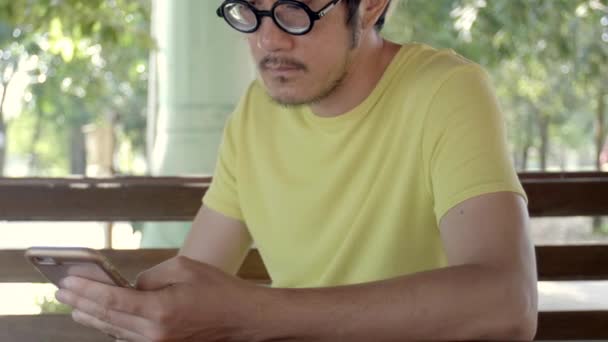 Slow Motion Casual Asian Man Using Smartphone Checking Mails Chats — Stock Video