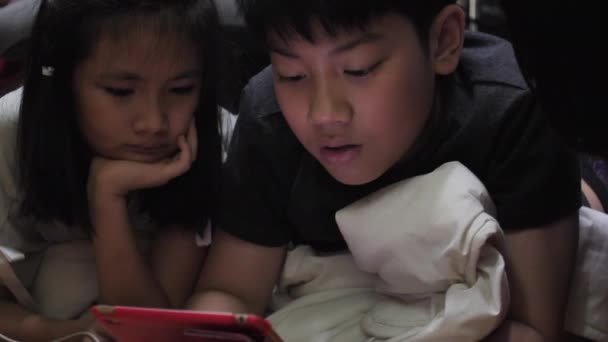 Asian Children Playing Tablet Cpmputer Home Recorded Hand Held Slow — Stock Video