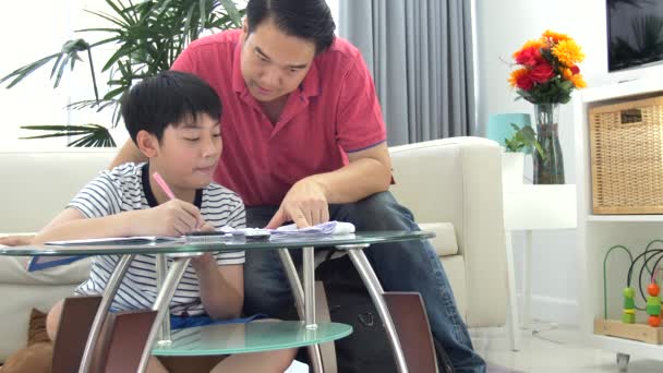 Asiático Padre Hijo Haciendo Tarea Mesa Sala Estar — Vídeo de stock