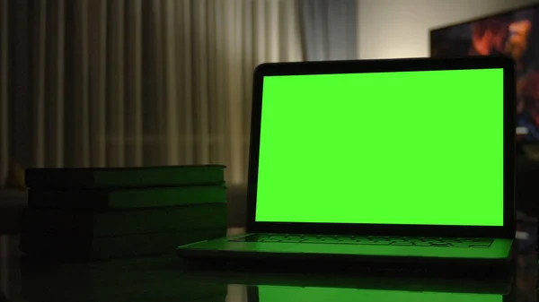 Close-up shot , Laptop with green screen indoors for replacement with blur background