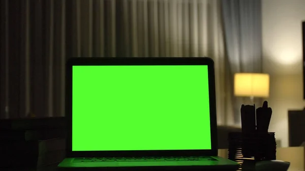 Close-up shot , Laptop with green screen indoors for replacement with blur background