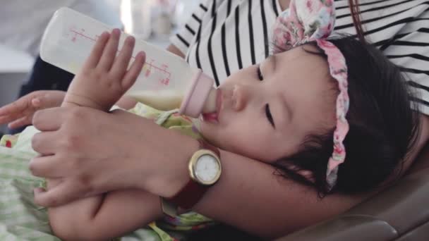 アジアの母親は 笑顔で自宅でミルクのボトルを供給し 幸せなアジアの家族の概念 — ストック動画