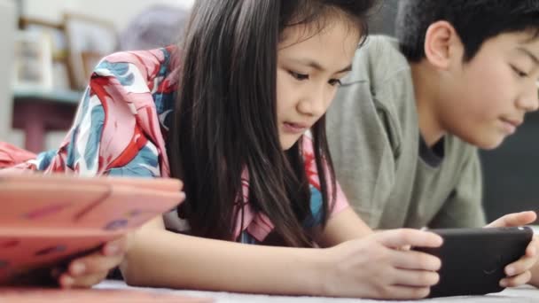 Дитина Грає Планшетом Або Смартфоном Вдома Азіатський Хлопчик Дівчинка Грають — стокове відео