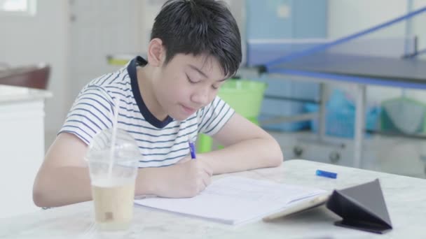 Asian Boy Sits Chair Home Doing Homework Using Tablet Find — Stock Video