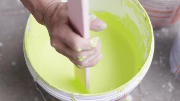 Man Mixes Bucket Paint Stick — Stock Video