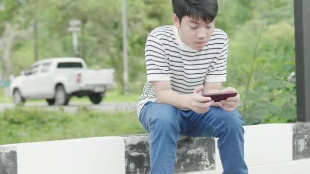 Азиатский Мальчик Подросток Играет Игру Мобильном Рядом Дорогой Волнительным Лицом — стоковое видео