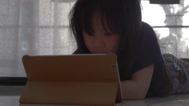 Aziatisch Klein Meisje Kijken Video Digitale Tablet Thuis — Stockvideo