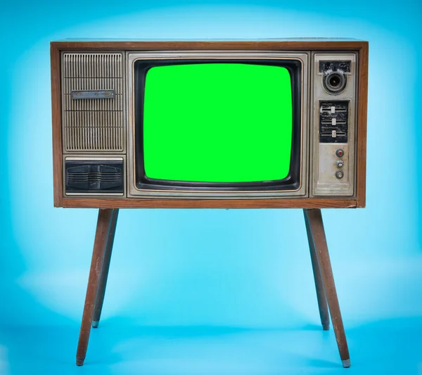 カットアウト画面とヴィンテージレトロスタイルの古いテレビ 青の背景に古いテレビ 緑の画面のテレビ ストックフォト