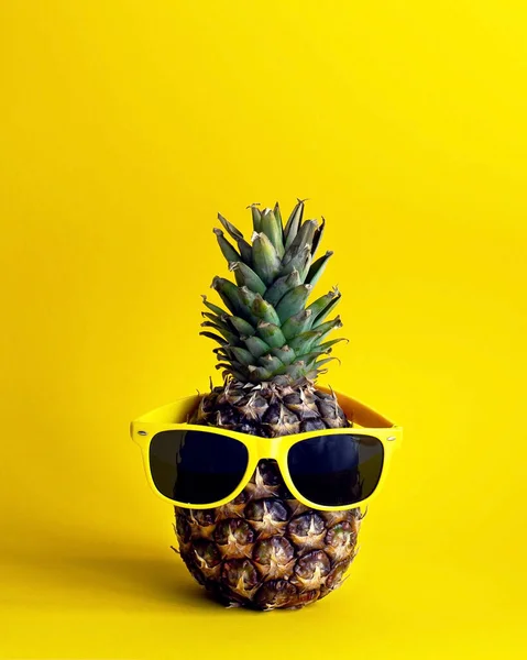 stock image Pineapple on a yellow background with yellow glasses