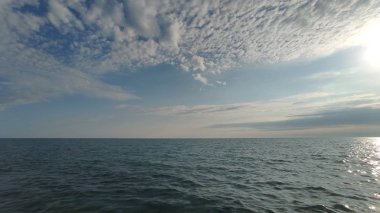 Mavi gökyüzü ve deniz üzerinde bulutlar