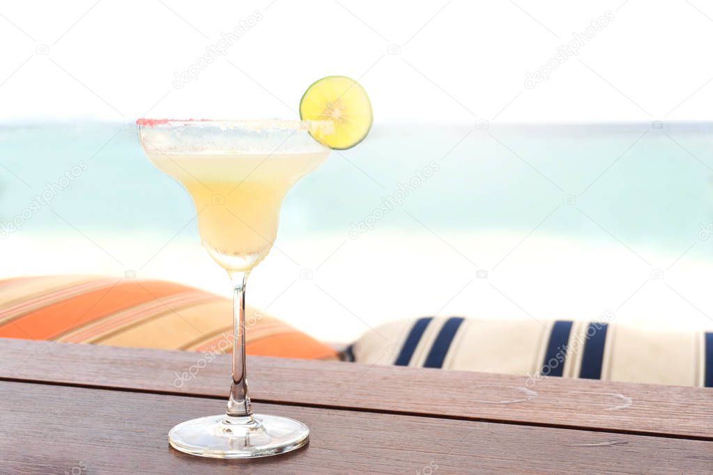 The frozen glass of Vodka cocktail on the beach