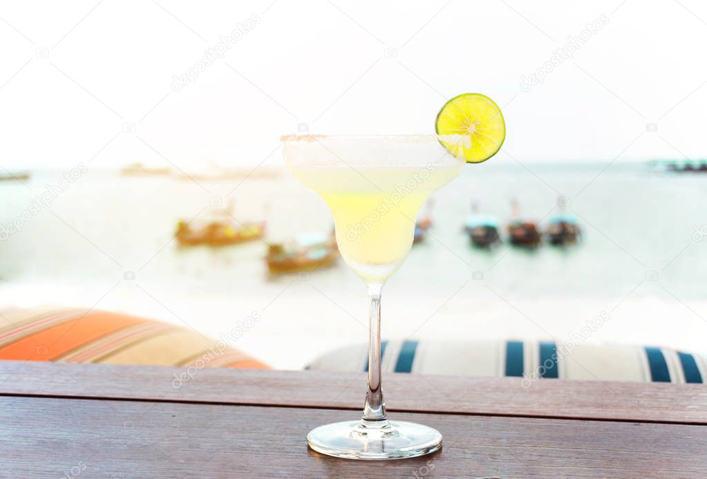 The frozen glass of Vodka cocktail on the beach