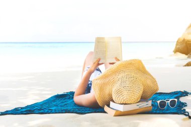 Summer Beach Holiday Woman reading a book on the beach in free t
