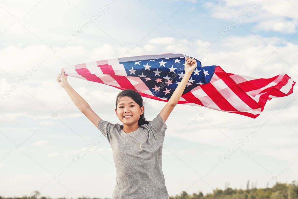Happy asian little girl with American flag USA celebrate 4th of 