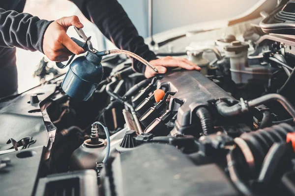 Technician Hands of car mechanic working in auto repair Service